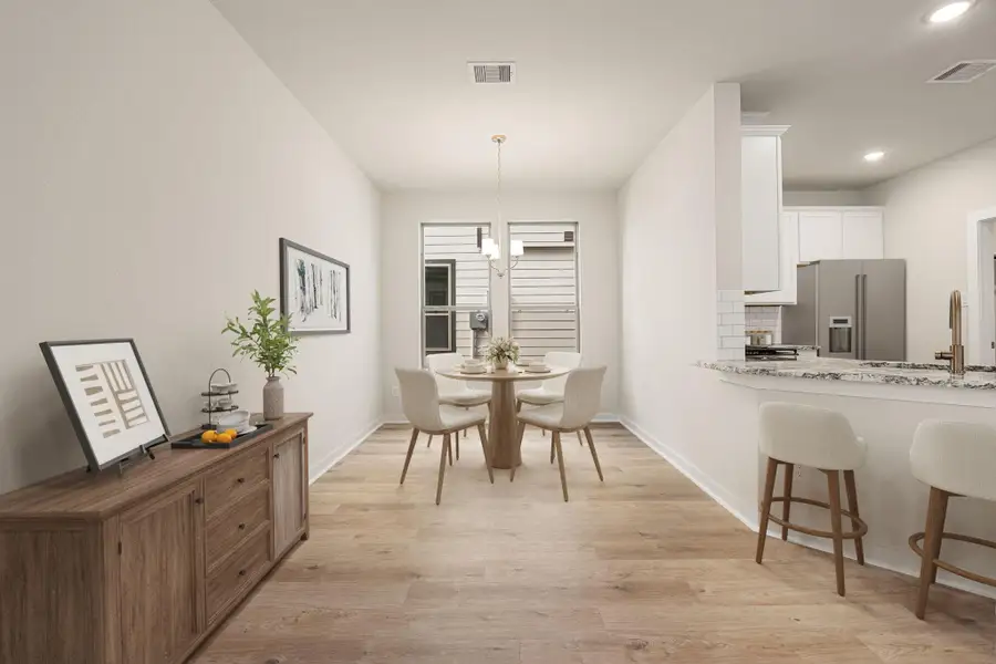 This bright and airy space showcases a beautiful open layout with an effortless flow between the dining area and kitchen. Large windows invite abundant natural light, highlighting the soft neutral palette and modern finishes throughout. The kitchen features sleek cabinetry, a spacious island with bar seating, and contemporary lighting that adds a touch of sophistication. Perfectly designed for both daily living and casual gatherings, this space embodies comfort, style, and functionality. This bright and airy space showcases a beautiful open layout with an effortless flow between the dining area and kitchen. Large windows invite abundant natural light, highlighting the soft neutral palette and modern finishes throughout. The kitchen features sleek cabinetry, a spacious island with bar seating, and contemporary lighting that adds a touch of sophistication. Perfectly designed for both daily living and casual gatherings, this space embodies comfort, style, and functionality.