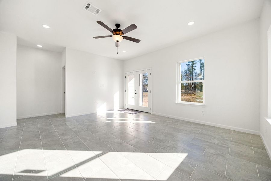Experience a bright, spacious living room with sleek tile flooring and abundant natural light, ideal for relaxation and entertaining, with seamless outdoor views. Experience a bright, spacious living room with sleek tile flooring and abundant natural light, ideal for relaxation and entertaining, with seamless outdoor views.