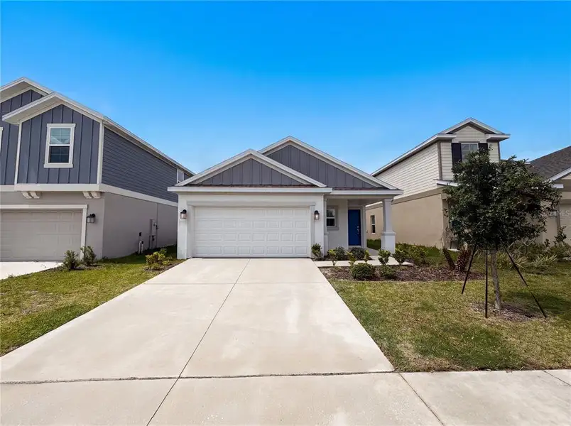 Front exterior of a new home in Cascades, Davenport, FL, highlighting curb appeal (Image 2). Front exterior of a new home in Cascades, Davenport, FL, highlighting curb appeal (Image 2).