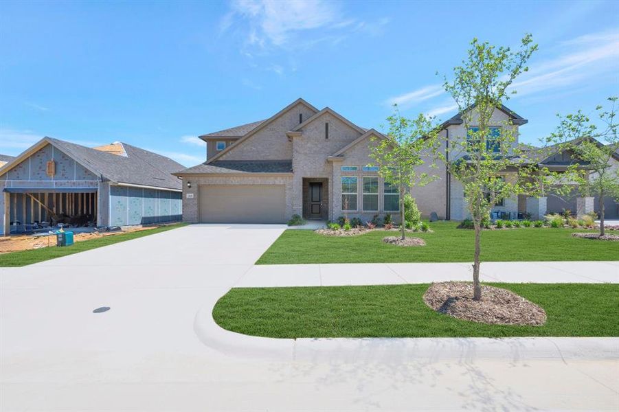 Front exterior of a new home in Vintage Village, Argyle, TX, highlighting curb appeal (Image 19).