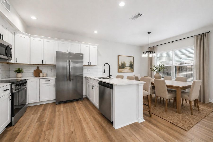 This modern kitchen is designed for both style and everyday convenience, featuring sleek white cabinetry with soft-close doors and drawers, stainless steel appliances, and durable quartz countertops accented by a contemporary backsplash. The open, spacious layout makes cooking and entertaining easy providing a perfect blend of functionality and modern design for comfortable living. (Photo virtually staged)