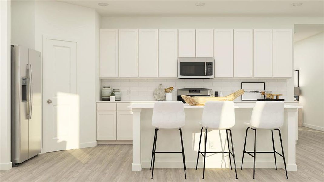 Kitchen featuring decorative backsplash, appliances with stainless steel finishes, light wood finished floors, and a center island Kitchen featuring decorative backsplash, appliances with stainless steel finishes, light wood finished floors, and a center island