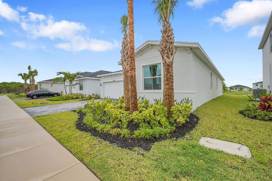 Front exterior of a new home in Seagrove: The Indies, Fort Pierce, FL, highlighting curb appeal (Image 13). Front exterior of a new home in Seagrove: The Indies, Fort Pierce, FL, highlighting curb appeal (Image 13).