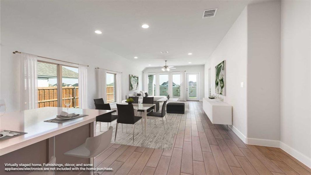 Dining room with light hardwood / wood-style floors and ceiling fan