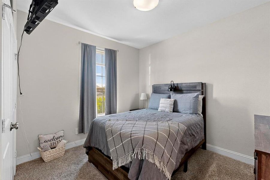 Bedroom featuring carpet flooring and baseboards Bedroom featuring carpet flooring and baseboards
