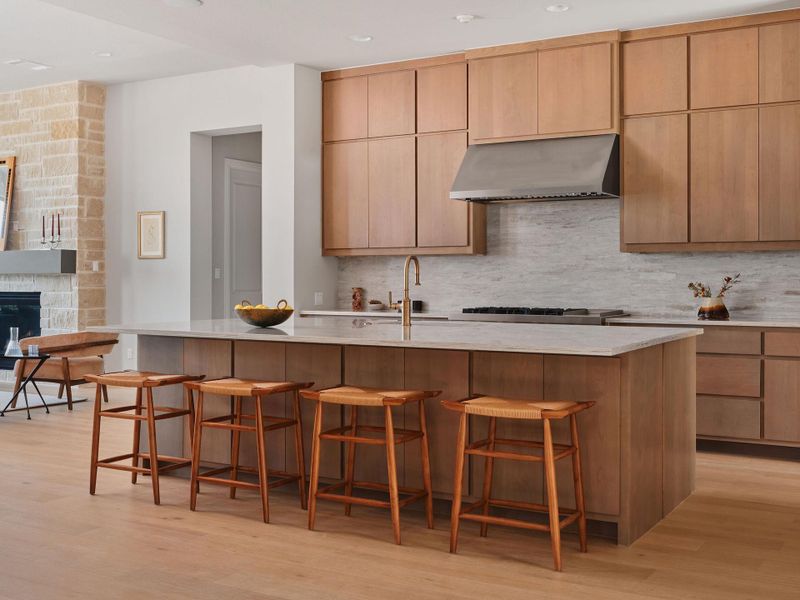 The chef’s kitchen features an elevated aesthetic with floor to veiling cabinetry.