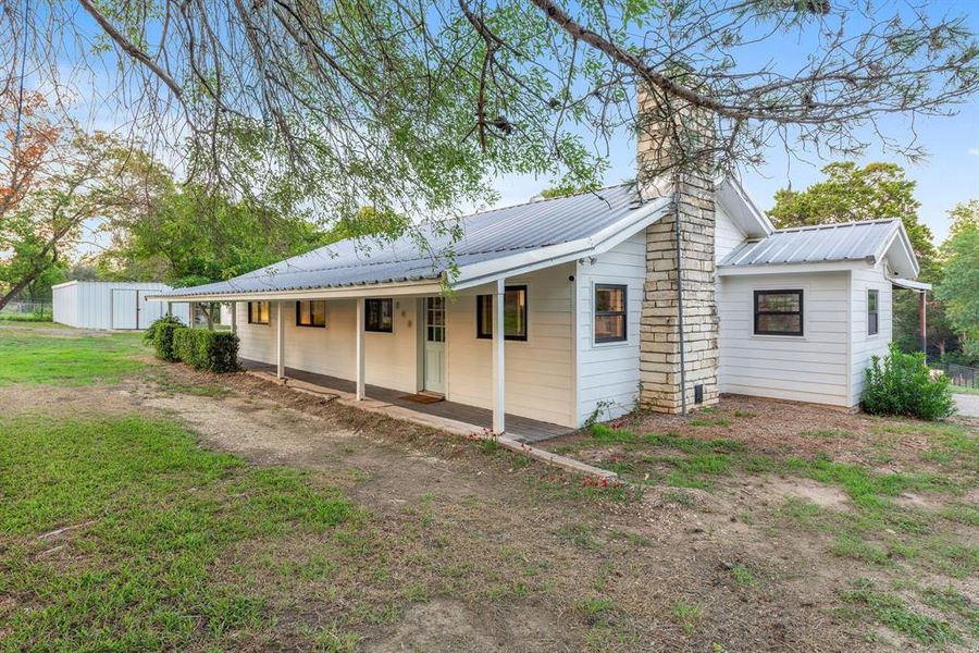 MAIN home with metal roof, all-new Hardie siding, and fresh exterior paint.