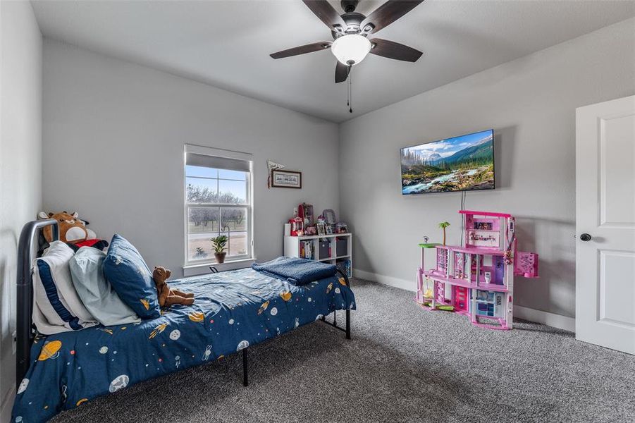 Bedroom featuring ceiling fan and carpet flooring