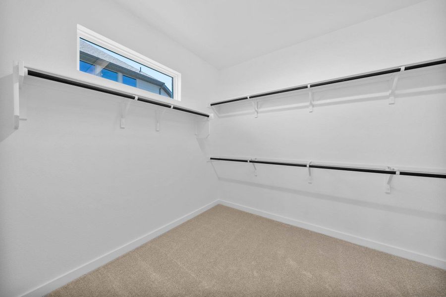 Walk-in closet in Primary Bedroom Walk-in closet in Primary Bedroom