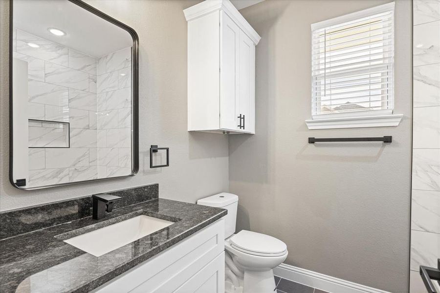 Guest Bathroom featuring vanity and toilet