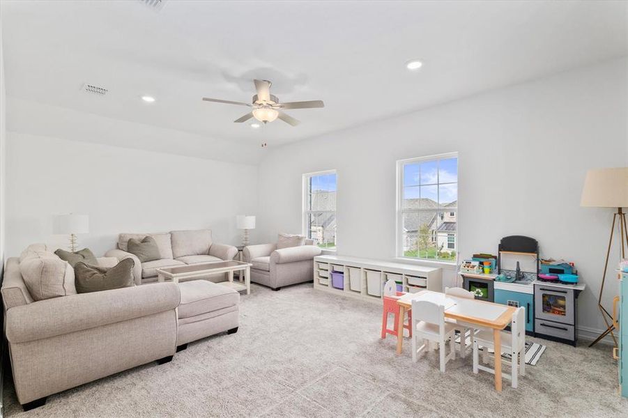 Living area featuring carpet, recessed lighting, and ceiling fan