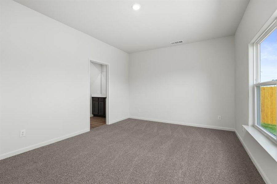 Spare room with dark carpet and recessed lighting