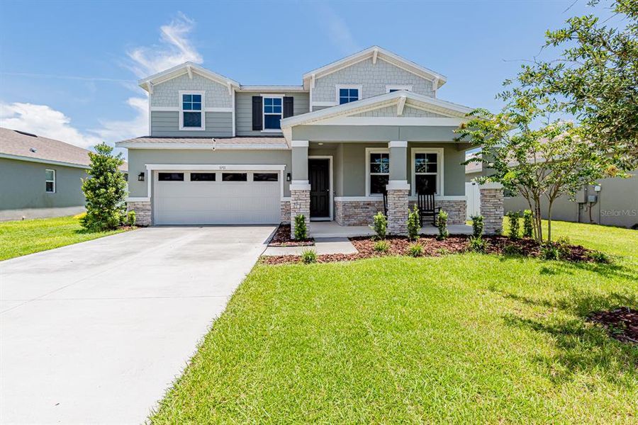 Front exterior of a new home in Seasons at Lakeside Forest, Tavares, FL, highlighting curb appeal (Image 20).