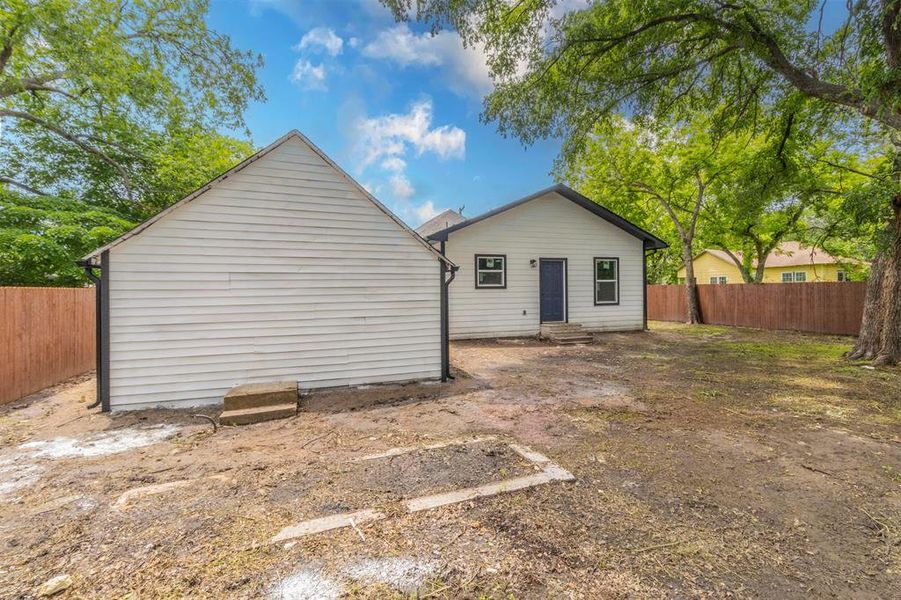 Back of house featuring entry steps and a fenced backyard Back of house featuring entry steps and a fenced backyard