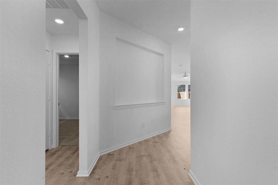Hall with recessed lighting and light wood-type flooring