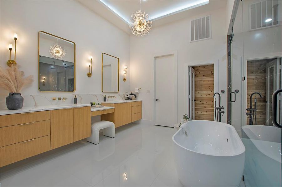 Bathroom with a towering ceiling, vanity, independent shower and bath, a chandelier, and tile patterned flooring