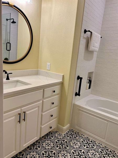 Bathroom with tile patterned flooring, vanity, and independent shower and bath