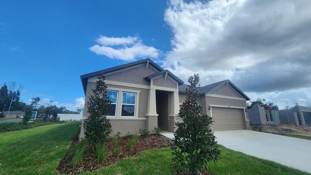 Front exterior of a new home in Pinecone Reserve, Brooksville, FL, highlighting curb appeal (Image 24).