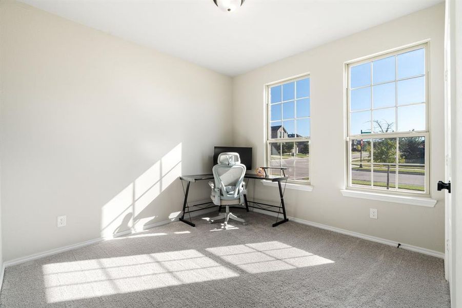 Unfurnished office featuring light colored carpet and baseboards Unfurnished office featuring light colored carpet and baseboards