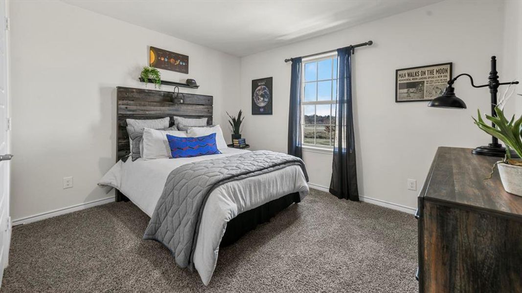 Carpeted bedroom featuring a textured wood-finish headboard with integrated shelving, a single window, and neutral wall paint