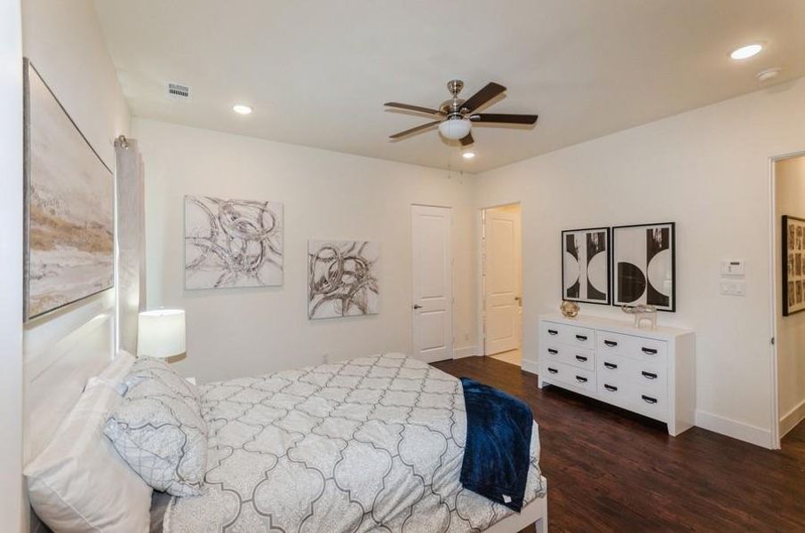 Bedroom featuring ceiling fan and dark hardwood / wood-style floors