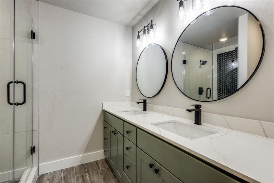 Bathroom featuring vanity, hardwood / wood-style floors, and an enclosed shower