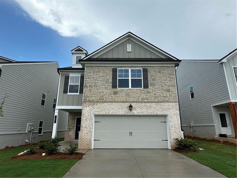 Front exterior of a new home in Kentmere, Auburn, GA, highlighting curb appeal (Image 2). Front exterior of a new home in Kentmere, Auburn, GA, highlighting curb appeal (Image 2).