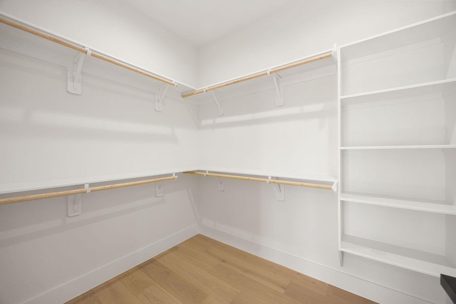 A generous walk-in closet offering ample storage and thoughtfully  designed organization space within the main primary suite.