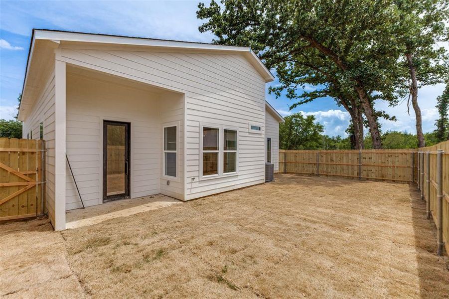 Expansive backyard featuring a new wood privacy fence Expansive backyard featuring a new wood privacy fence