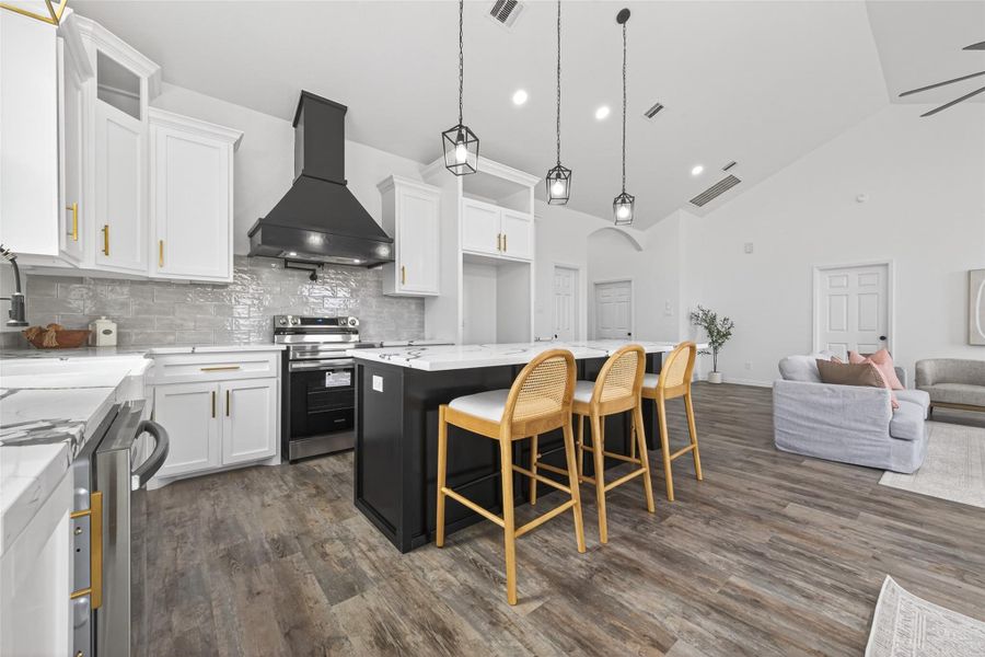 Modern kitchen featuring custom cabinetry, farmhouse sink, and large center island.