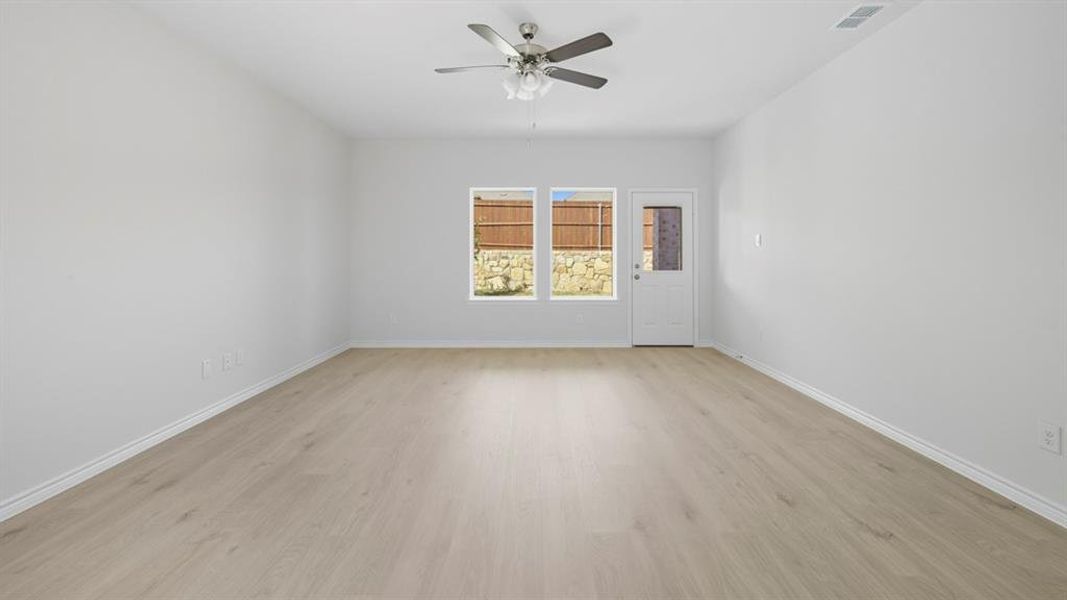 Spare room with light wood-style floors and a ceiling fan Spare room with light wood-style floors and a ceiling fan
