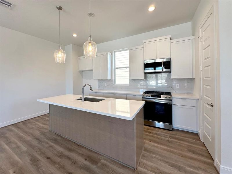 2nd Floor - Living Room open to dining. *Photos of previous model with similar floor plan.  Finishes will be based on spec for Erin Park community.*