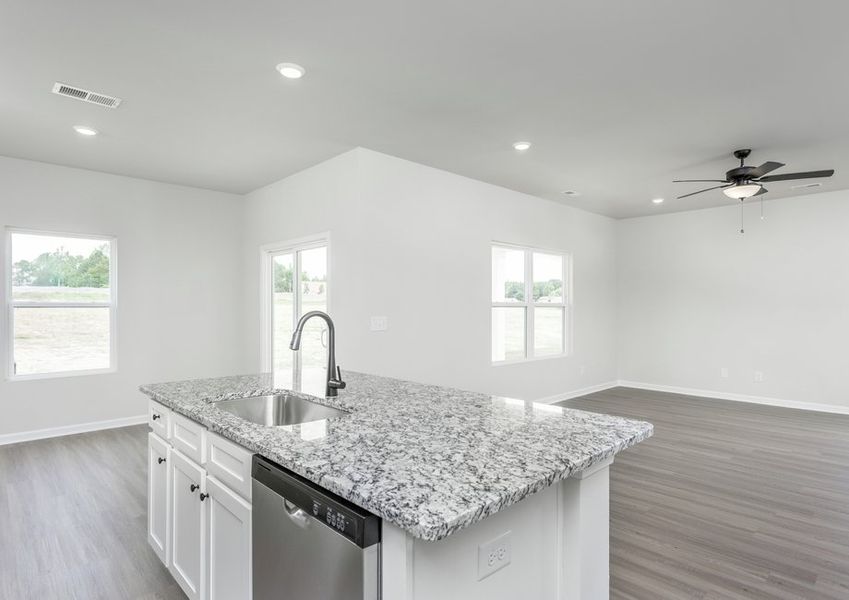 The kitchen has a granite island.