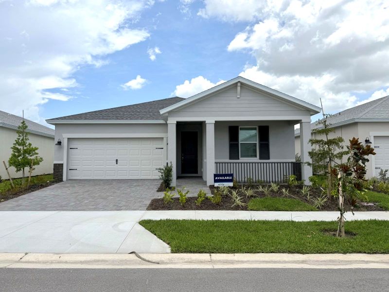 Front exterior of a new home in Crescent Lakes - Reserve Series, Punta Gorda, FL, highlighting curb appeal (Image 9).