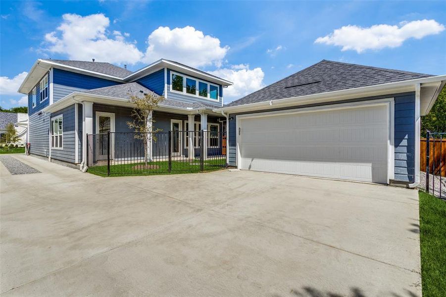 View of front of home featuring covered porch and a garage