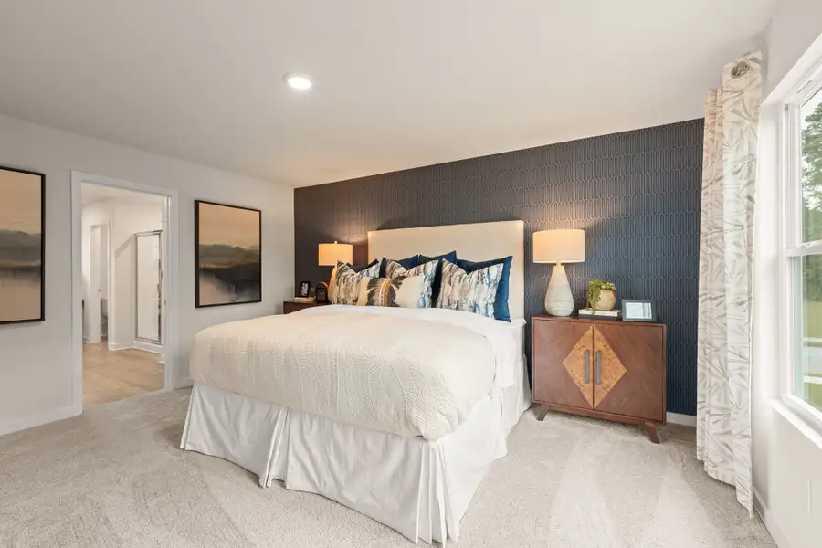 A bedroom with a bed and lamps. A bedroom with a bed and lamps.