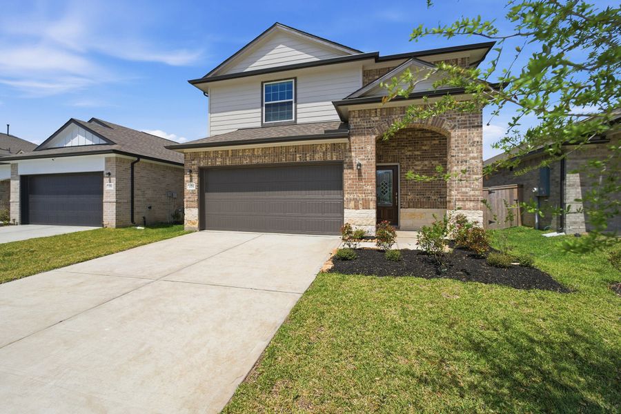 Front exterior of a new home in Windrose Green, Angleton, TX, highlighting curb appeal (Image 2).