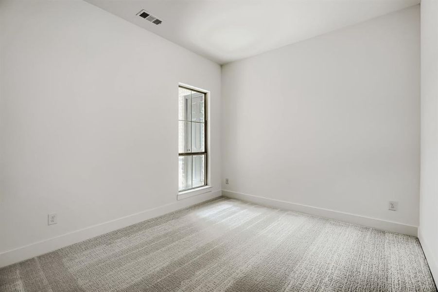 Unfurnished room featuring light carpet and baseboards
