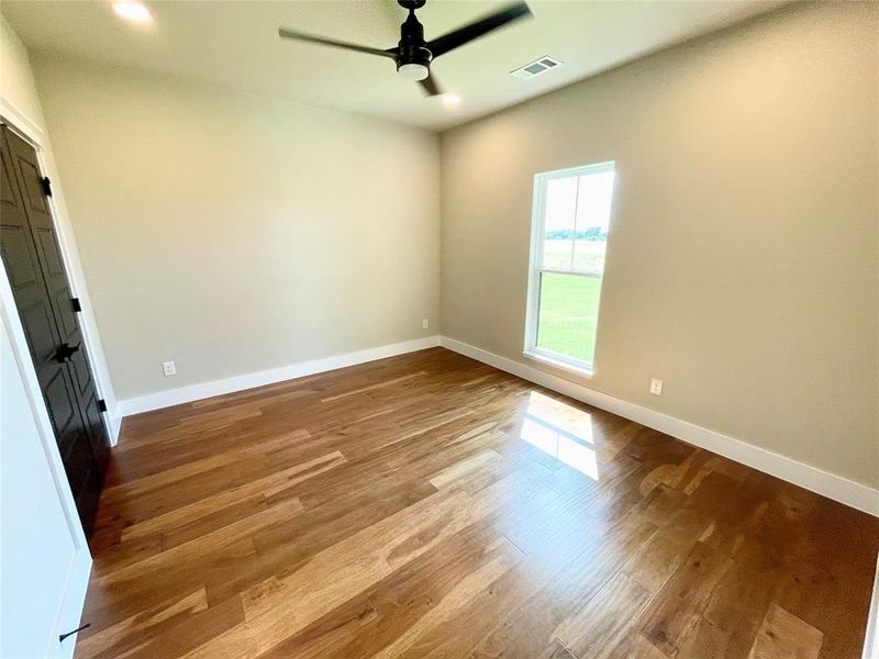 Unfurnished bedroom with light wood-type flooring and ceiling fan