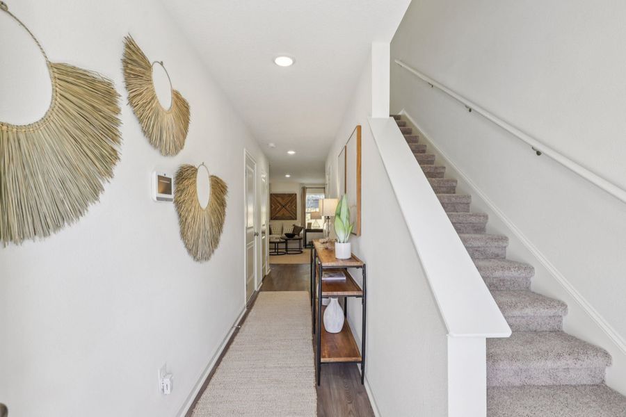A staircase with a table and chairs. A staircase with a table and chairs.