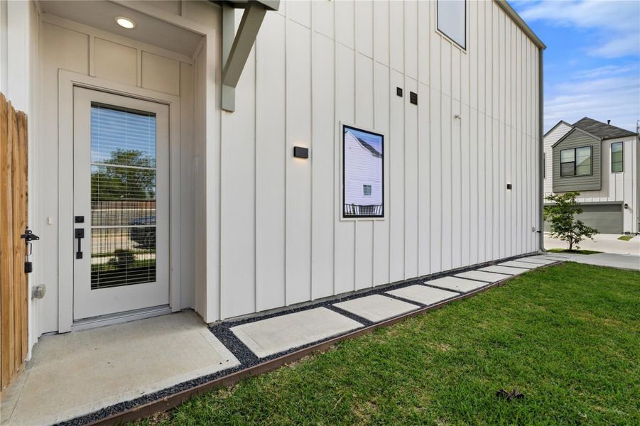 Defined by simplicity and precision, the entry features clean siding lines and thoughtfully placed lighting that elevates the exterior experience. Defined by simplicity and precision, the entry features clean siding lines and thoughtfully placed lighting that elevates the exterior experience.