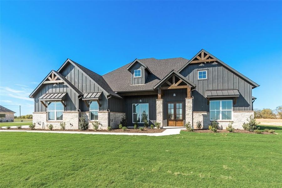 View of front of property with french doors and a front lawn