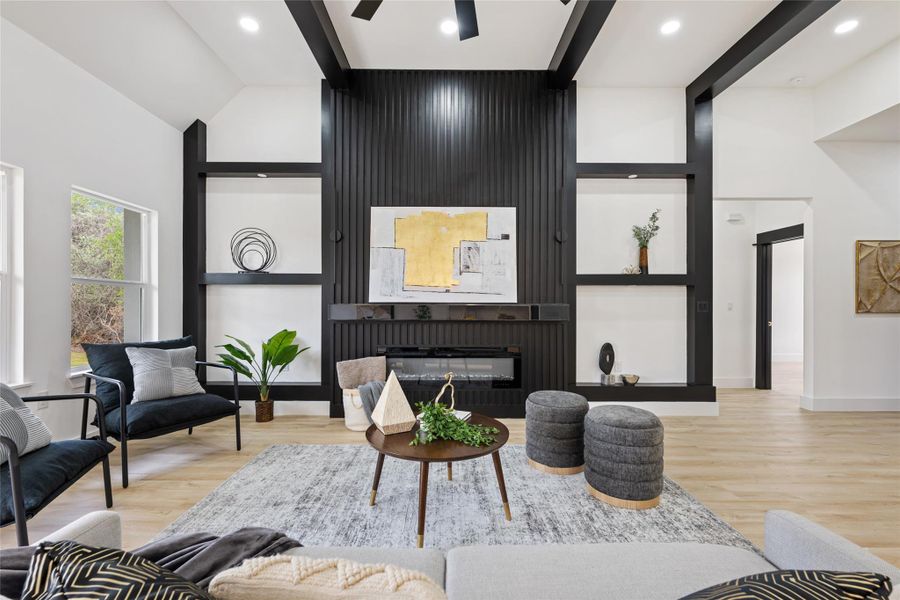 Living room featuring light wood finished floors, a large fireplace, recessed lighting, and a ceiling fan Living room featuring light wood finished floors, a large fireplace, recessed lighting, and a ceiling fan