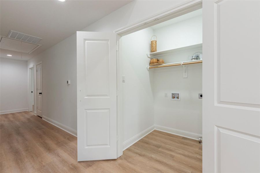 Large utility room in house with built in shelving.