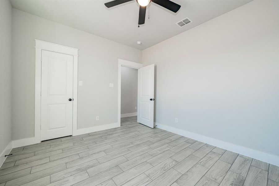 Bedroom with wood-tiled floors and ceiling fan Bedroom with wood-tiled floors and ceiling fan