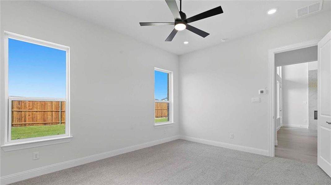 Unfurnished bedroom with carpet, ceiling fan, and recessed lighting