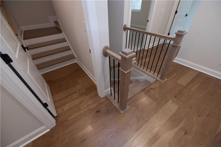 Stairs featuring baseboards and wood finished floors