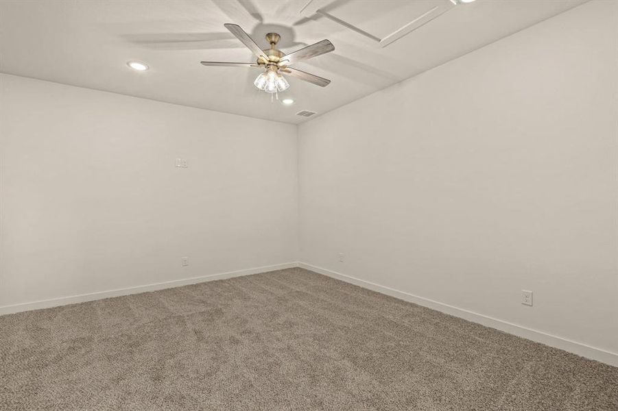 Carpeted empty room featuring a ceiling fan, baseboards, and recessed lighting