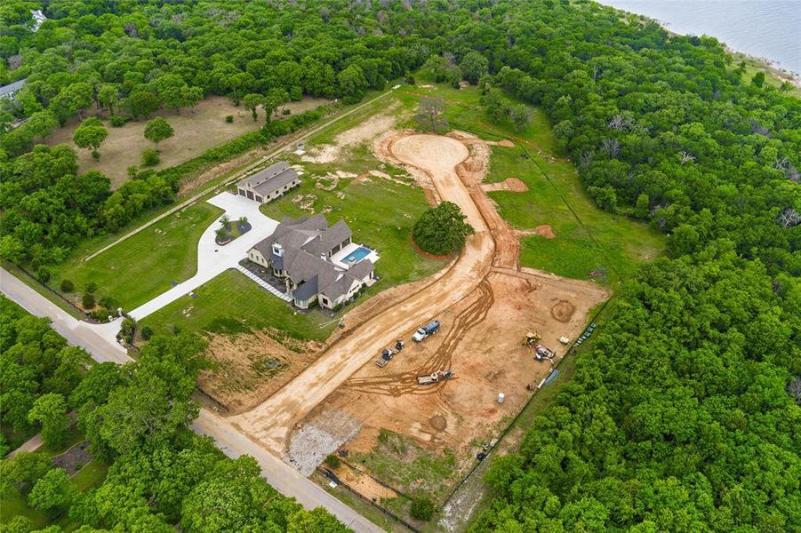 Expansive property featuring a large residence, detached auxiliary building, swimming pool, and extensive wooded areas Expansive property featuring a large residence, detached auxiliary building, swimming pool, and extensive wooded areas