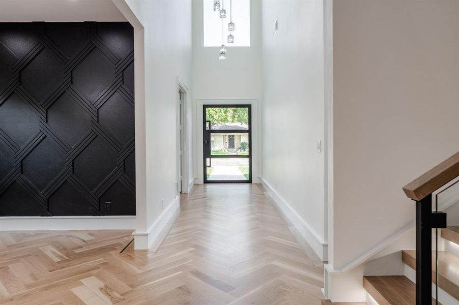 Foyer with plenty of natural light, stairs, and a high ceiling Foyer with plenty of natural light, stairs, and a high ceiling